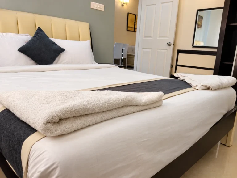 Apartment bedroom with king bed and soft linen, Le Villagio Wayanad