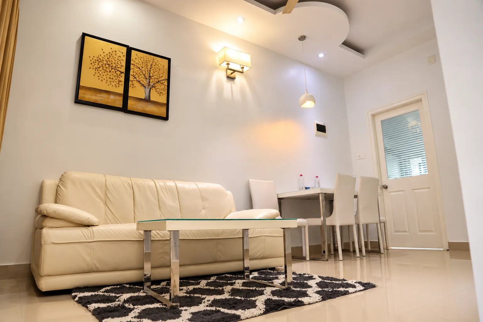 Family apartment lounge with sofa and dining table, Le Villagio Wayanad