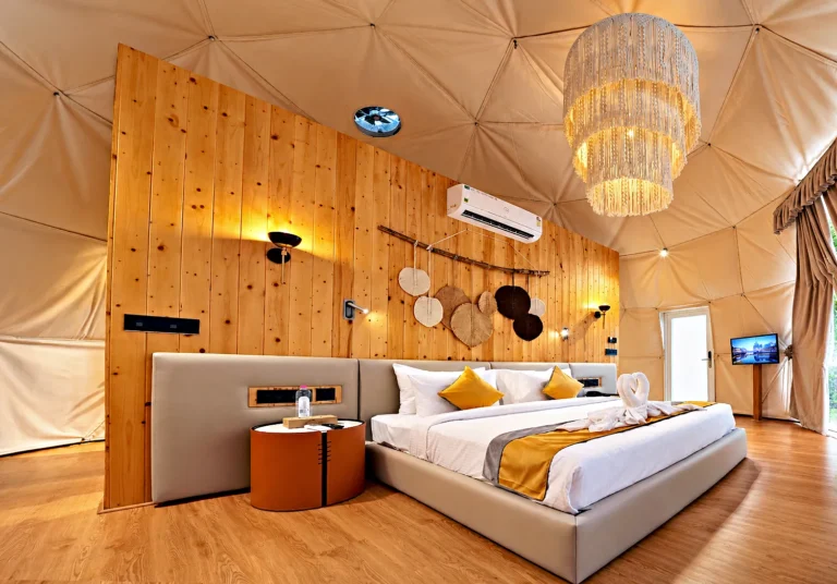 Dome suite bedroom warm timber – Le Villagio Resort & Domes, Wayanad