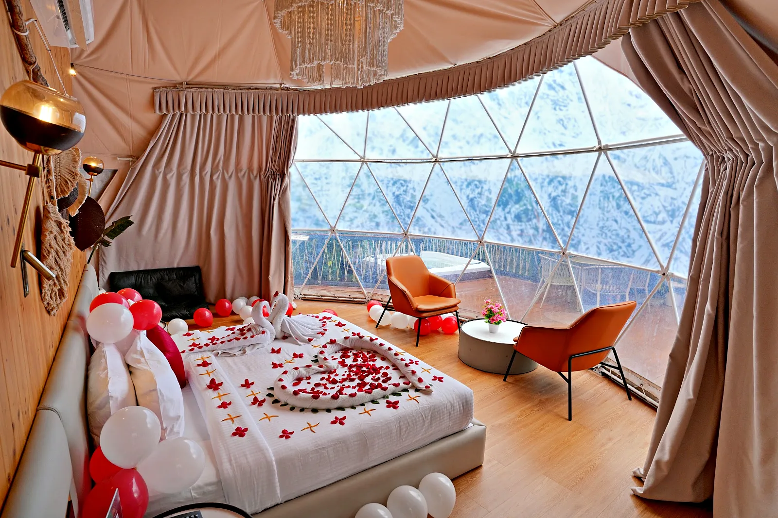 Honeymoon glamping dome decorated with roses and balloons, Le Villagio Wayanad