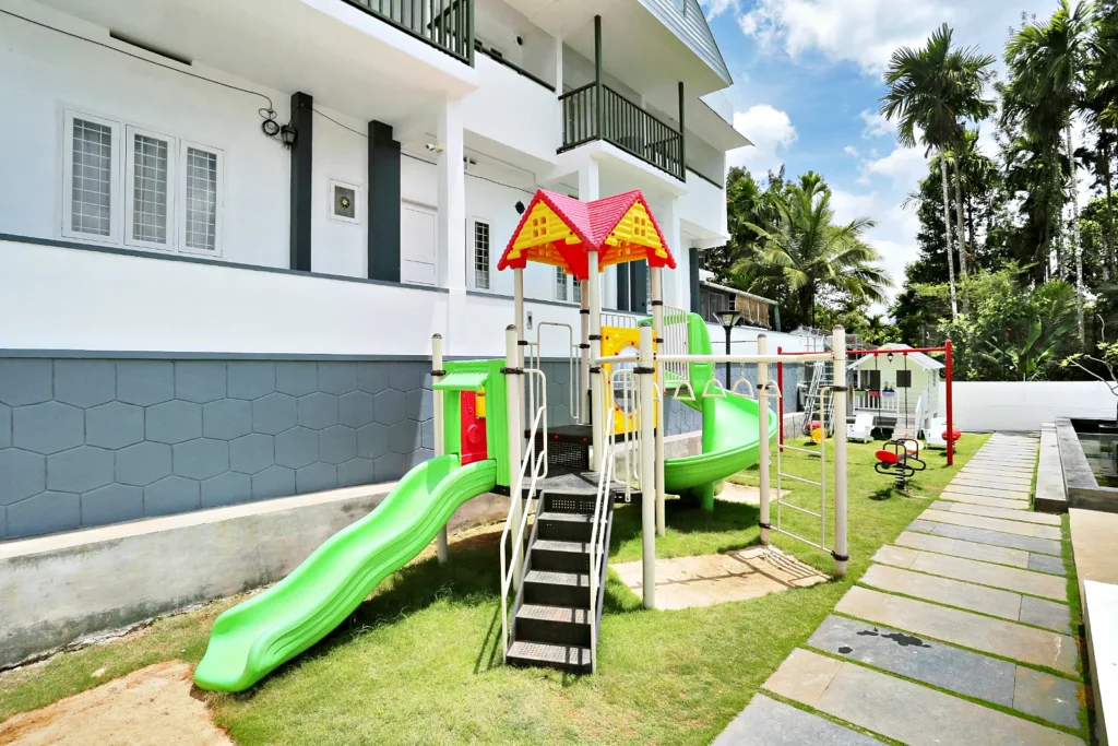 Kids play area with slide and climbing frame, Le Villagio Wayanad
