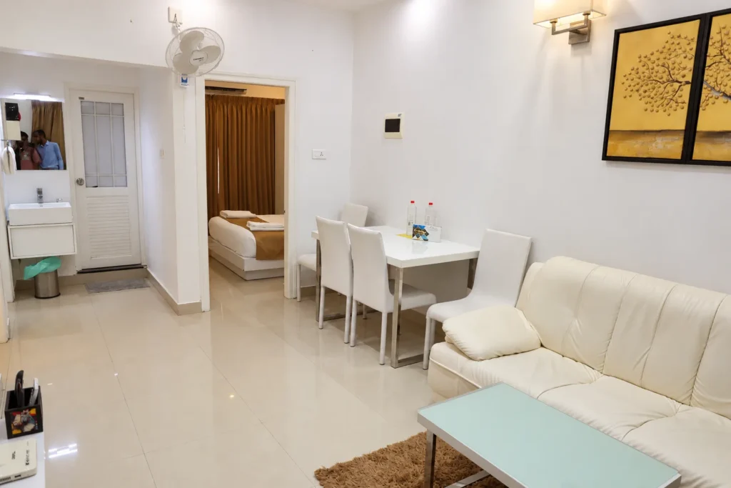 Open-plan family apartment with living and dining area, Le Villagio Wayanad