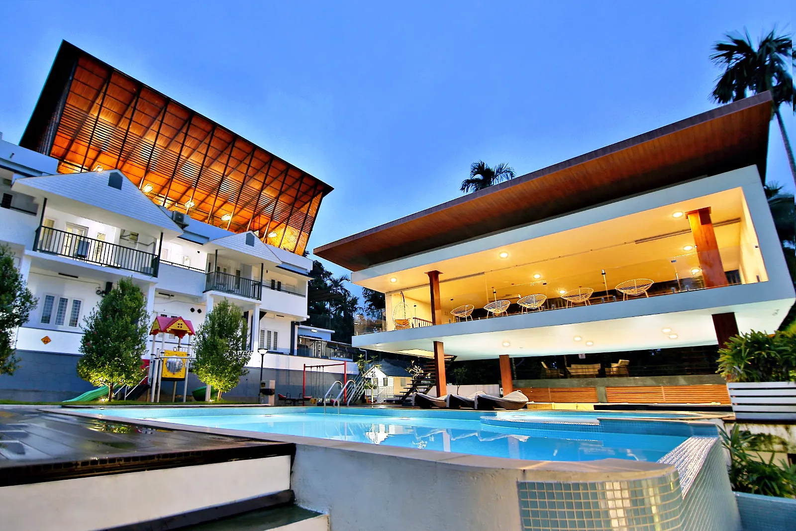 Resort pool apartments dusk – Le Villagio Resort & Domes, Wayanad