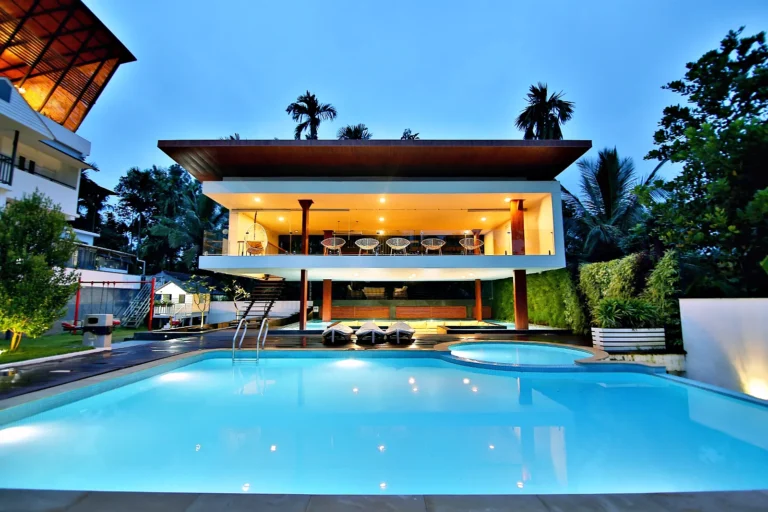 Resort pool and restaurant pavilion at blue hour, Wayanad