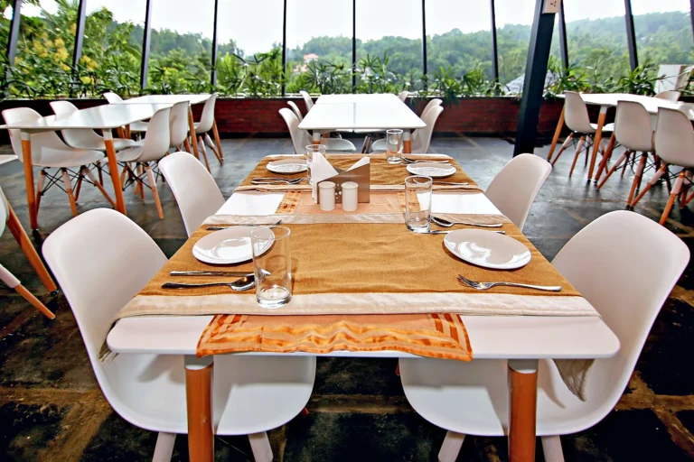 Restaurant table set for dinner at Le Villagio, Wayanad
