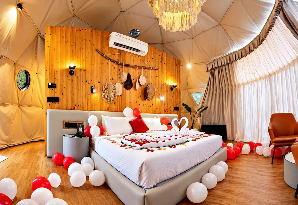 Romantic dome retreat with swan towels and balloon decor