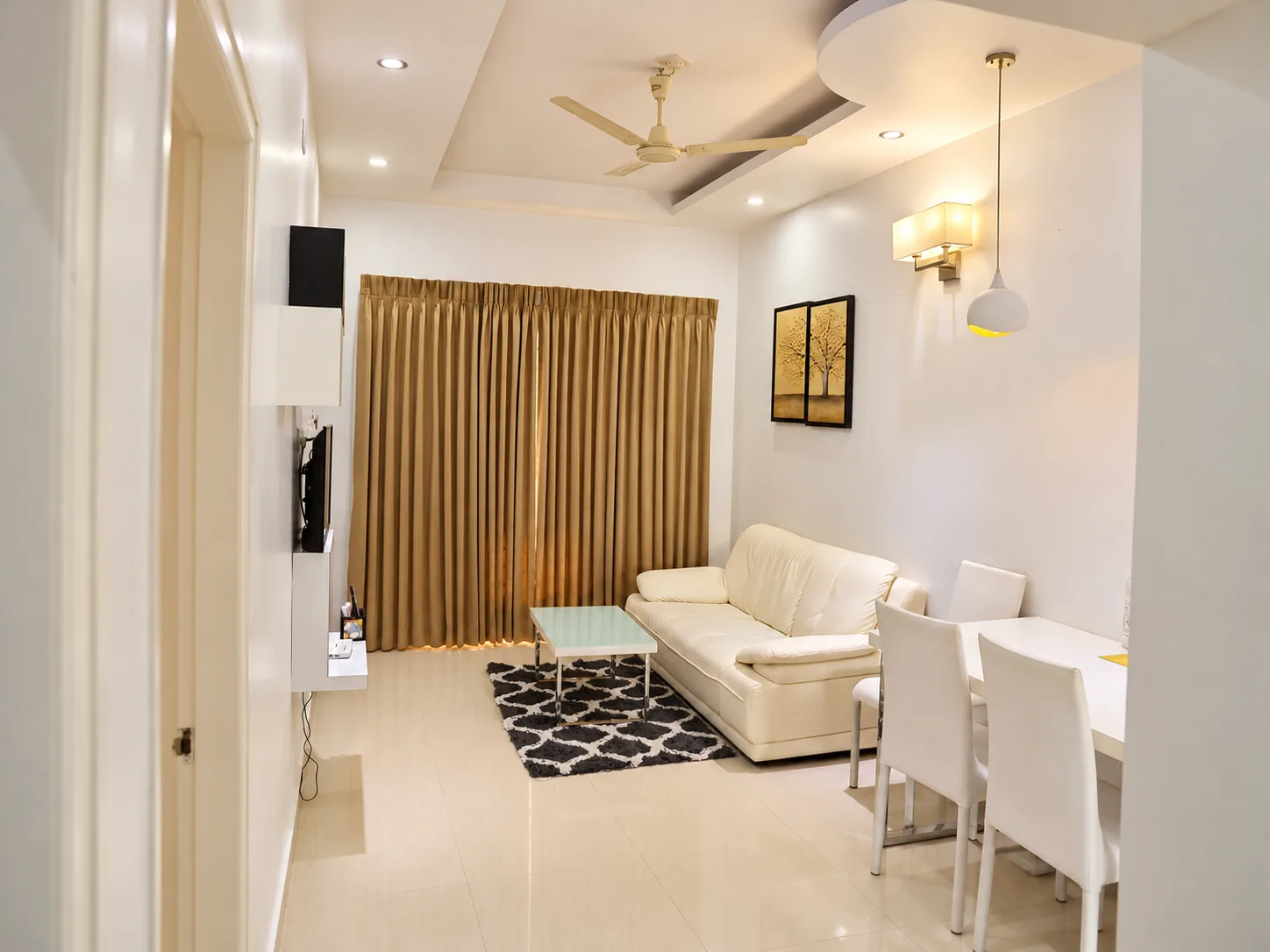 Bright serviced apartment living and dining room, Le Villagio Wayanad
