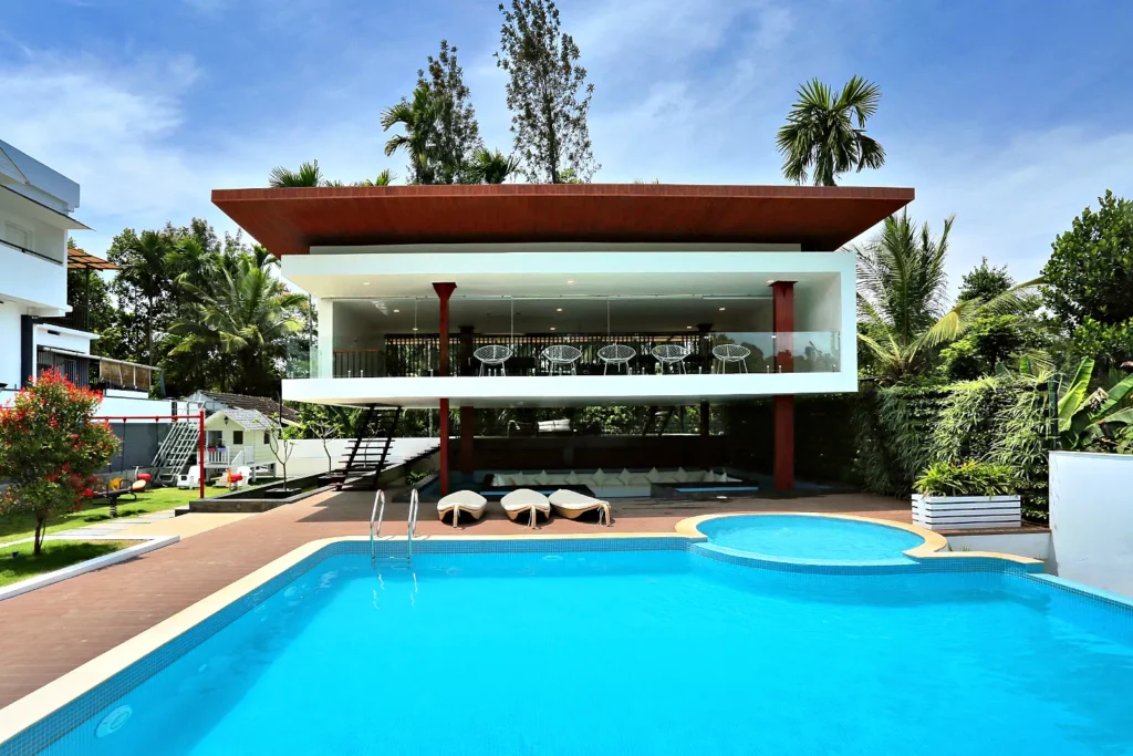 Swimming pool sunny day – Le Villagio Resort & Domes, Wayanad