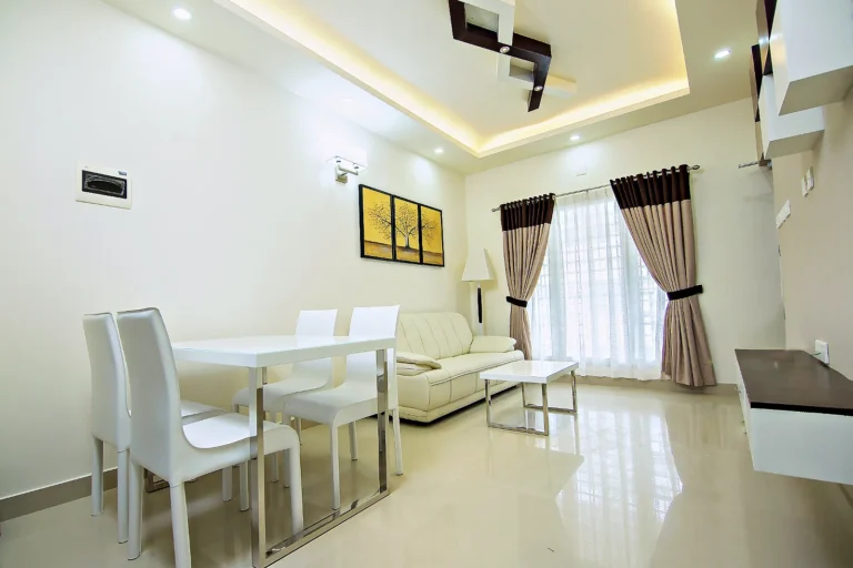 Two-bedroom apartment dining area and lounge, Le Villagio Wayanad