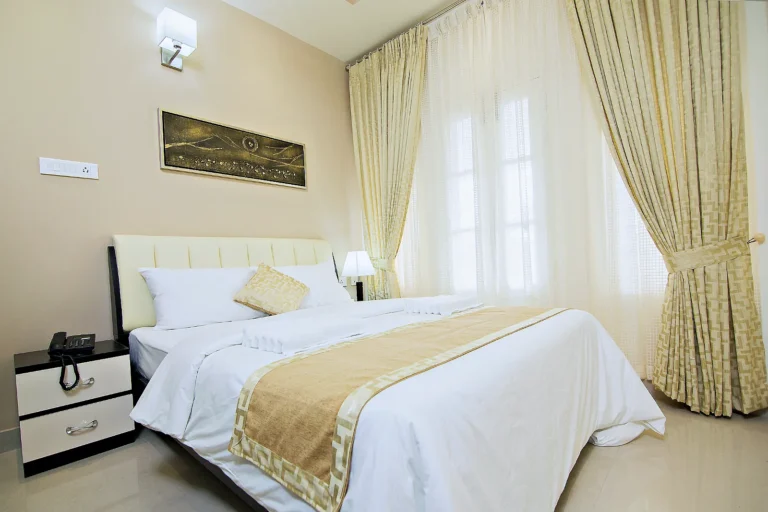 Bedroom in a two-bedroom balcony apartment with king bed, Le Villagio Wayanad